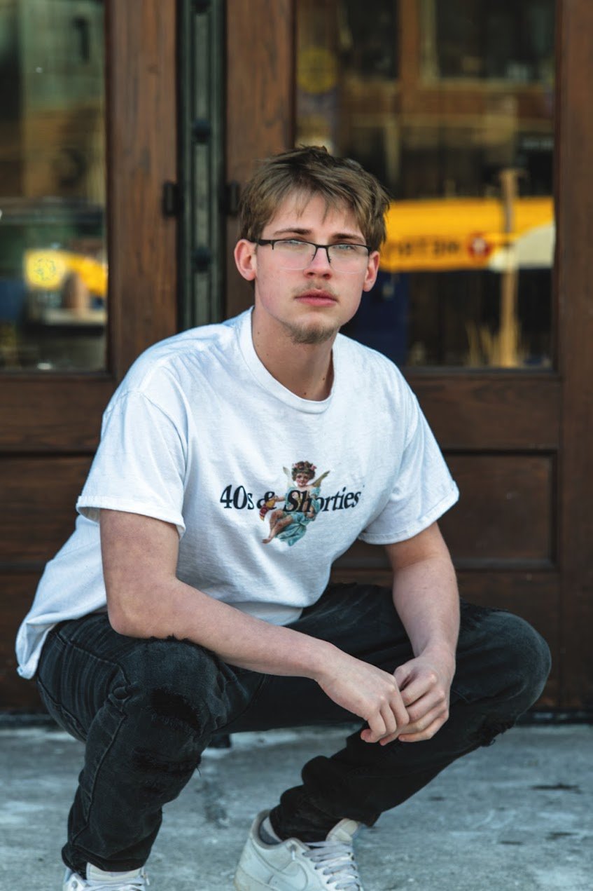 Senior posing in front of glass door - creative senior portraits Minneapolis MN