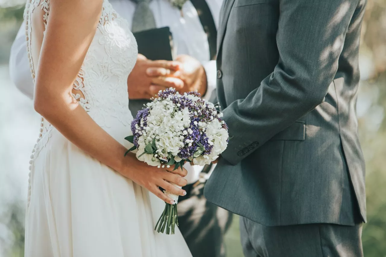 Couple holding hands during wedding ceremony